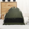 Military green portable cat tent and cooling mat pet bed set up indoors on white carpet near wooden drawer unit