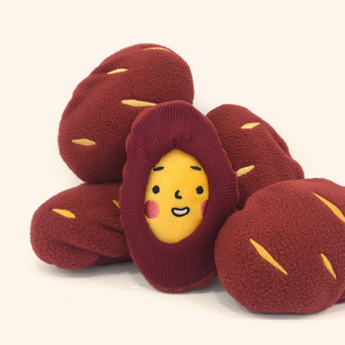 Snack-stuffed plush toy shaped like a sweet potato with a smiling face for dogs to unwrap and play with
