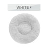 White fluffy donut dog bed with ultra-plush, calming design for cats and dogs, featuring raised rim and soft long plush texture.