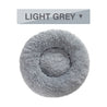 Light grey fluffy donut dog bed with ultra-plush, calming design for cats and dogs, washable and available in multiple sizes.