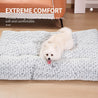 Small white fluffy dog lying on luxury rose velvet ultra-plush round dog bed providing extreme comfort and support