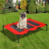 Elevated red mesh pet bed with steel frame and non-skid feet for dogs on grass outdoors