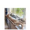 Two cats relaxing on a hanging cat window hammock mounted on a sunny window sill.
