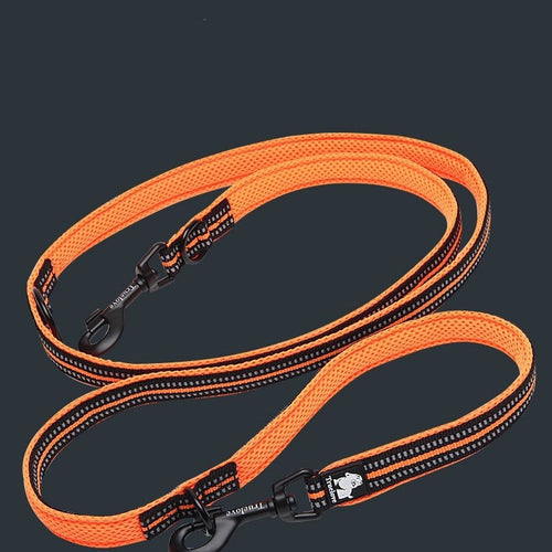 Bright orange double ended dog lead with black clips and reflective stitching on a dark background