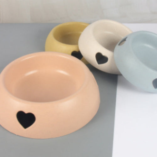 Colorful replacement pet product dog bowls with heart-shaped cutouts, available in pastel shades of beige, yellow, white, and blue.