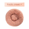 Fairy pink fluffy donut dog bed with ultra-plush fabric and raised rim for calming comfort.